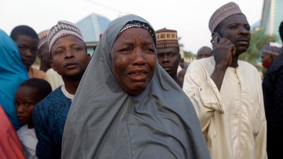 Nigerian families weep after their children were kidnapped from school (AP Photo/Sunday Alamba)